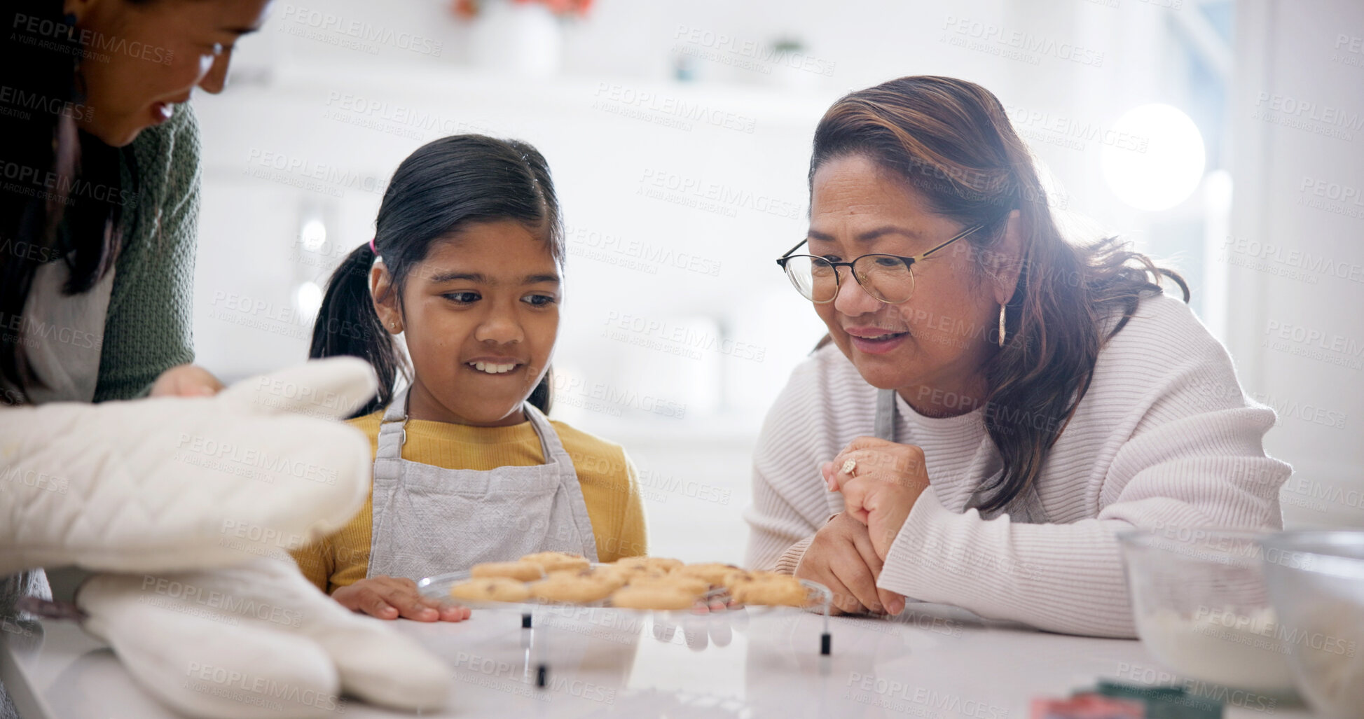 Buy stock photo Cookies, happy and child with grandma and mother in home for baking results, snack or sweet treat. Family, bonding and girl kid with mom and senior woman for biscuits in kitchen at apartment.