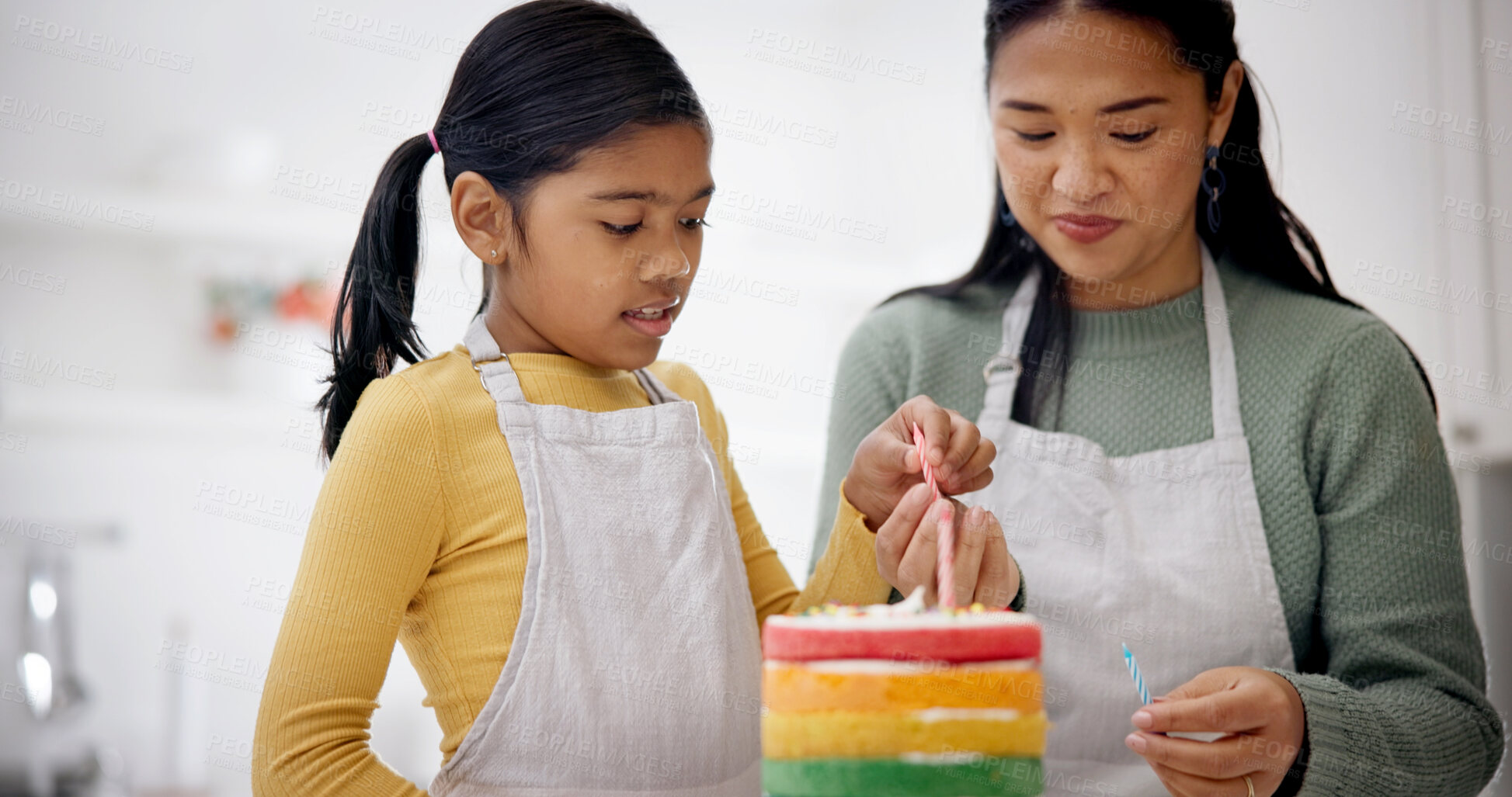Buy stock photo Kid, mother and candles on birthday cake for baking at home, celebration and special day. Parent, decoration and girl with rainbow dessert at party for help, preparation or learning in family kitchen
