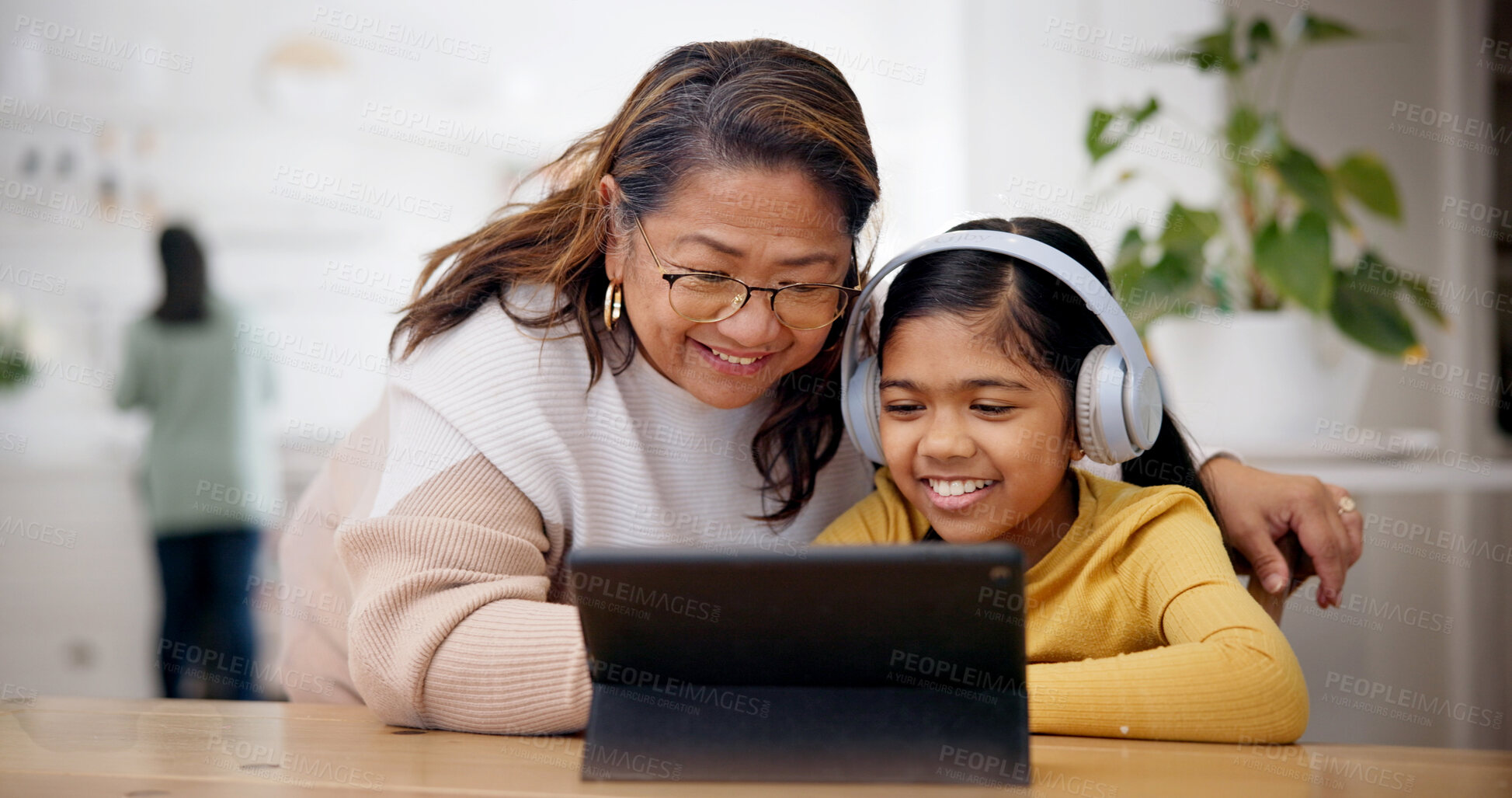 Buy stock photo Tablet, headphones and grandmother with kid for elearning, online lesson or studying in home. Digital technology, help and senior woman with girl child for virtual class with development in house.