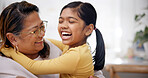 Laughing, grandmother and child with hug in home for support, affection and security for weekend visit. Happy, senior woman and girl with embrace for connection, relationship development and bonding