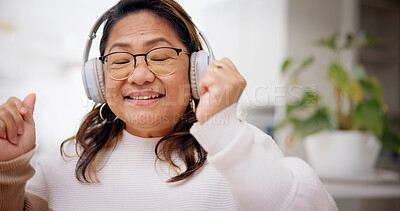 Buy stock photo Dance, streaming or senior woman in home with headphones, rhythm or listening to music playlist. Happy, space or person in living room with tech, feeling beat or radio subscription on audio app.