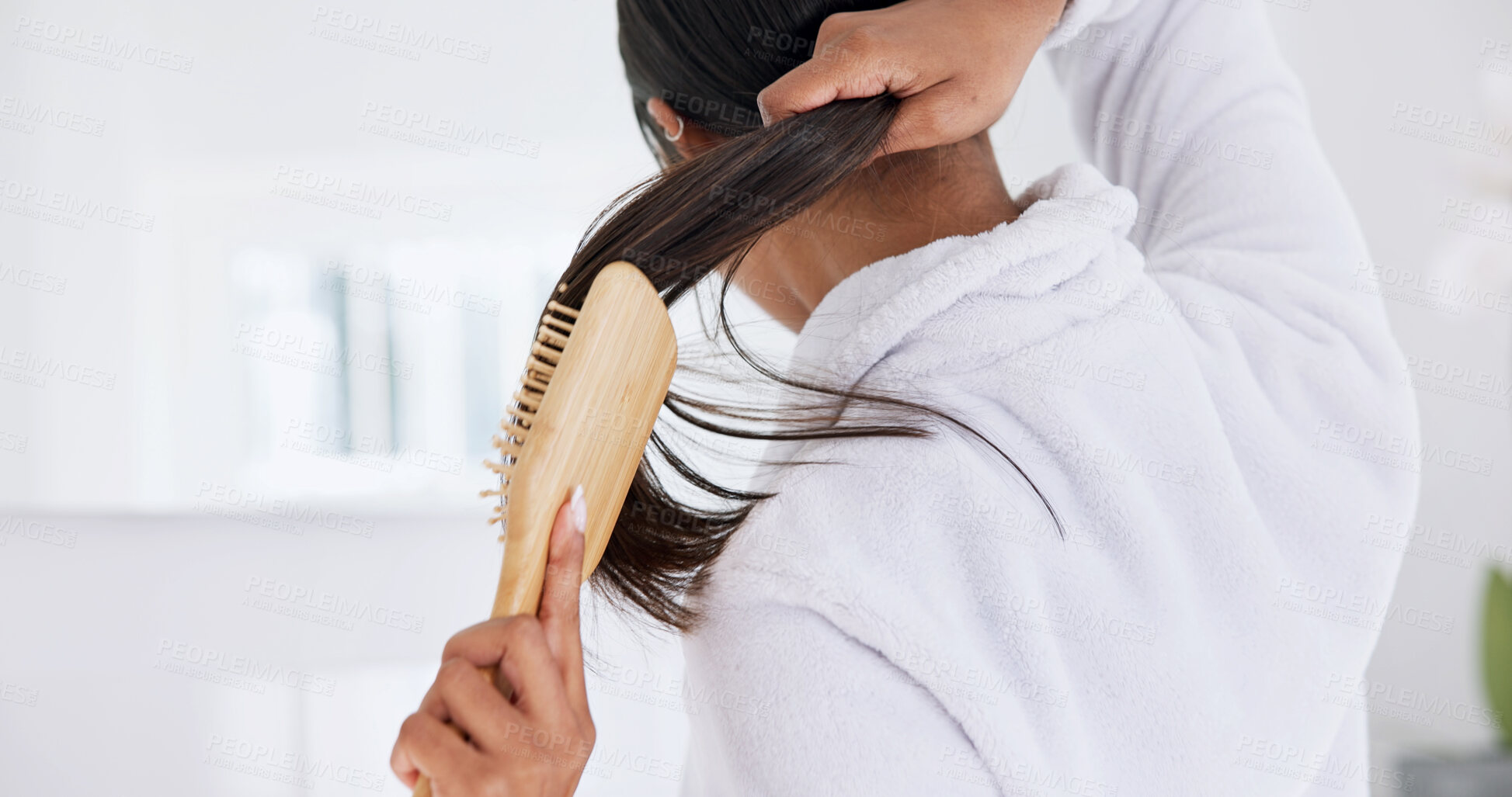 Buy stock photo Hands, brushing hair and haircare in bathroom with back, morning routine and grooming in home. Bamboo brush, female person and self care in house for beauty, texture and getting ready with tools