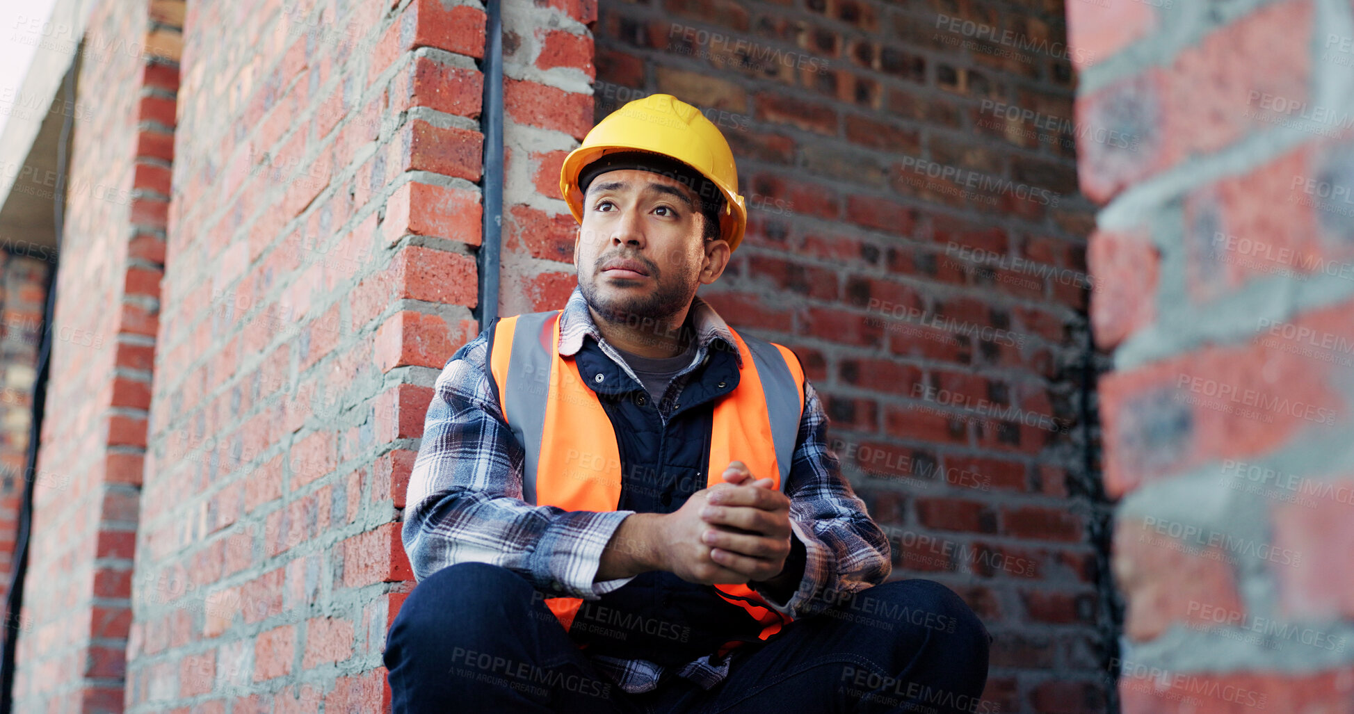 Buy stock photo Man, architect or thinking with helmet in building site for construction break or rest on brick wall. Male person, civil engineer or thoughtful contractor chilling with hard hat for safe architecture