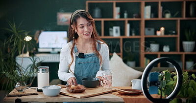 Buy stock photo Vlog, phone and happy woman with drink for tutorial, diet or herbal beverage recipe in home. Female person, influencer or smile with natural ingredients, ring light or smartphone for online guide