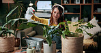 Plant, spray and leaf with woman in home for botany hobby, gardening or sustainability. Eco friendly, horticulture and water maintenance with person and headphones in living room of house for growth