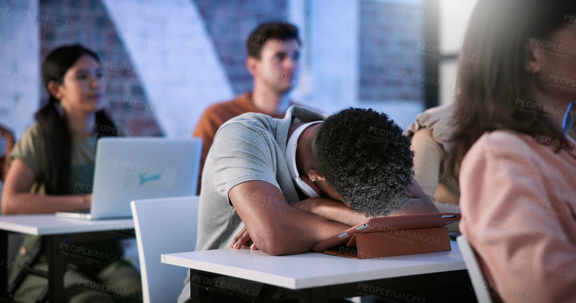 Buy stock photo Tired, student and sleeping in classroom with tablet, education and lesson for academic exam. Fatigue, man and asleep in study hall with digital, learning lecture and burnout from college assessment