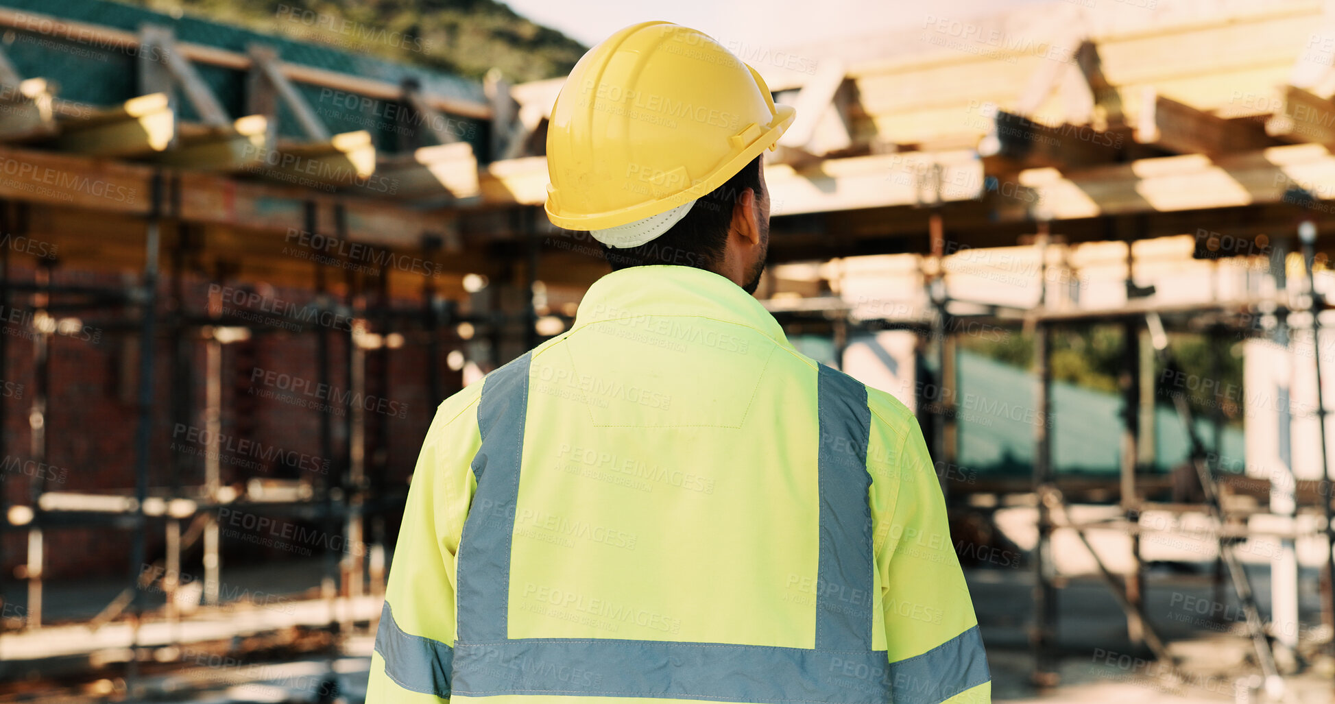 Buy stock photo Thinking, outdoor and back of man on construction site for planning, inspection and evaluation. Architecture, engineer and person with idea, ppe and helmet for remodeling, renovation and building