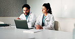 Doctors, team and laptop with meeting at hospital in boardroom, pointing and planning for healthcare. People, medical professional and insight with computer, feedback or services at wellness clinic