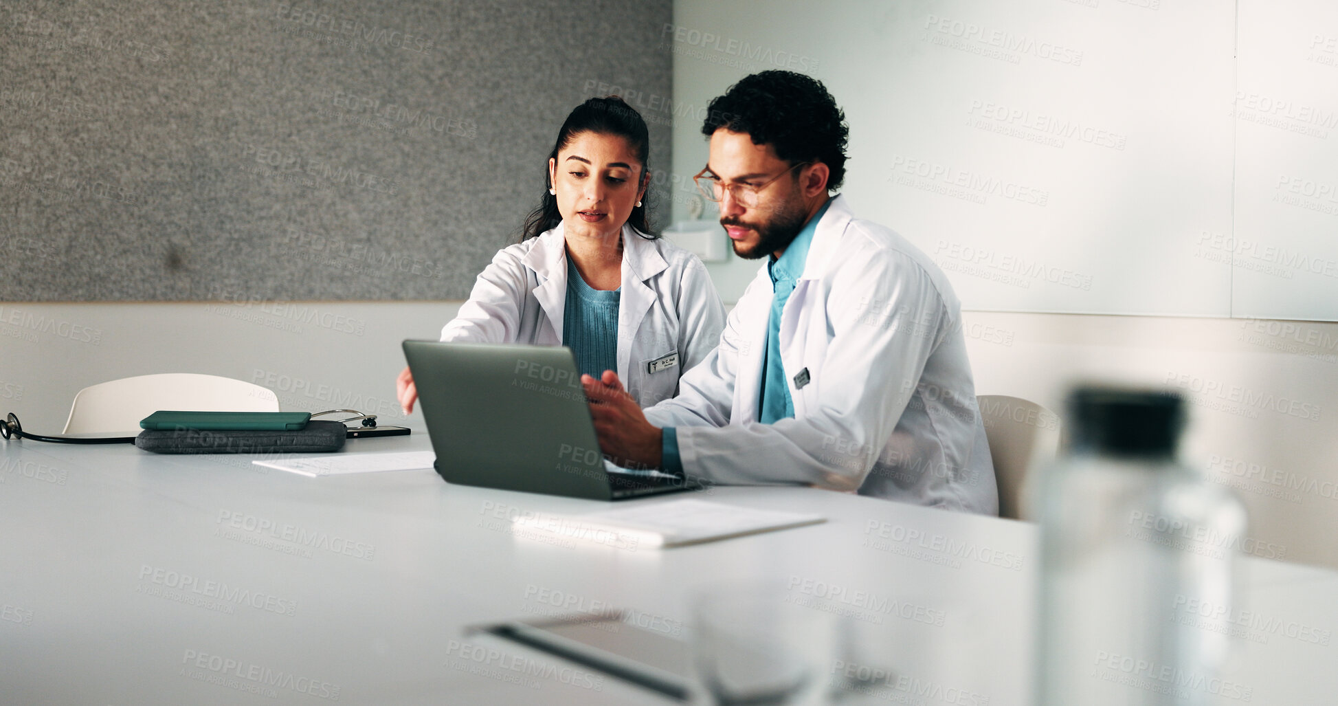 Buy stock photo Doctors, team and laptop with review at hospital in boardroom, meeting and planning for healthcare. People, medical professional and insight with computer, feedback or services at wellness clinic