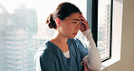 Nurse, woman and sad with stress in clinic for patient loss, operation failure or medical trauma. Health professional, person or unhappy at hospital window for healthcare crisis, grief or overwhelmed