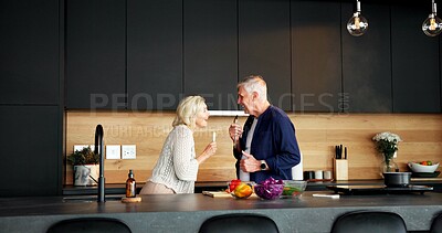 Buy stock photo Smile, couple and cooking in home with singing, celebration and playful for meal prep. Happy, mature people and karaoke at house with utensils, listening to music and anniversary for romantic lunch