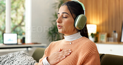 Buy stock photo Woman, breath and headphones on couch for meditation, spiritual healing or holistic audio for zen. Person, relax or eyes closed in home with calm music, inner peace or inhale guidance for mindfulness