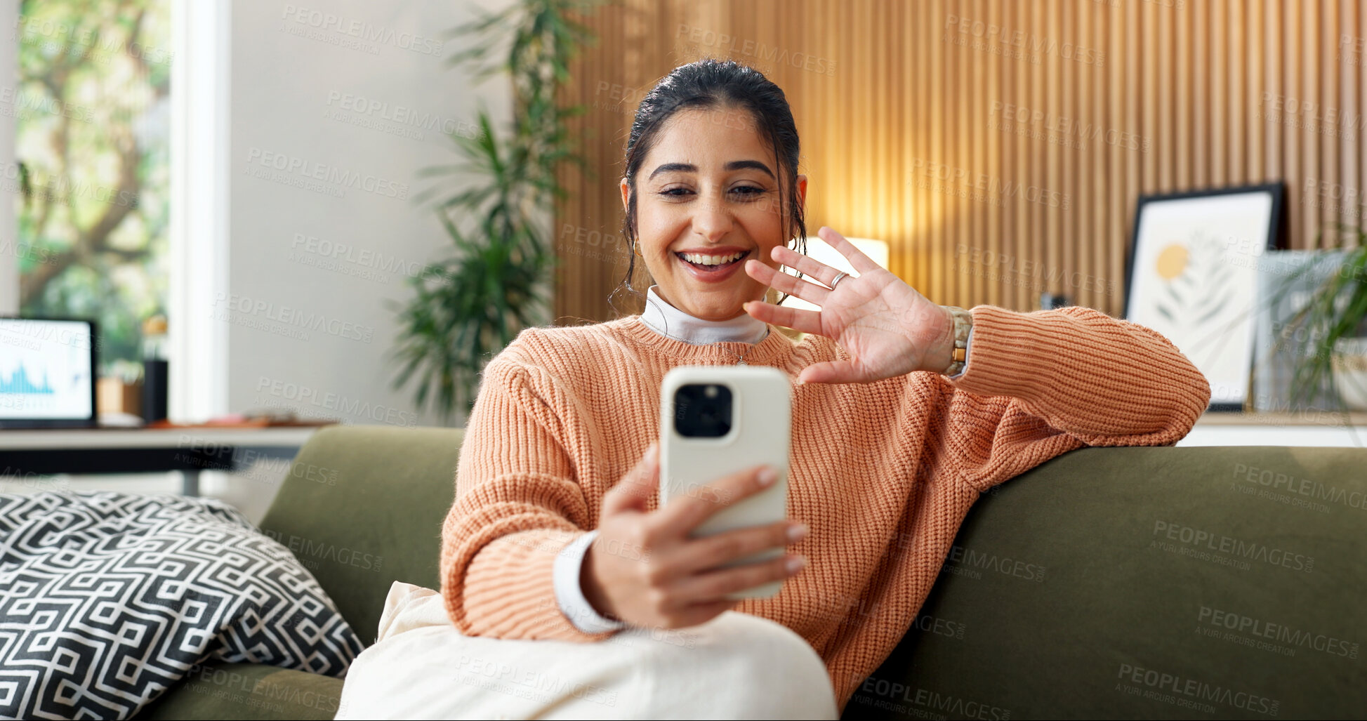 Buy stock photo Video call, wave or woman in house with phone, online chat or digital greeting on dating site. Smile, hello or person on couch with gesture, virtual conversation or connection on matchmaking platform