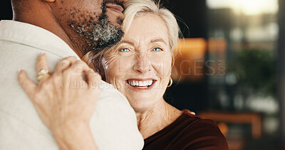 Buy stock photo Hug, smile and interracial couple in home with trust, connection and relationship wellness. Mature man, woman and embrace with partner for love, security and commitment together with funny portrait