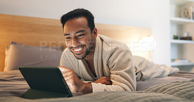 Buy stock photo Reading, online and man with tablet on bed, entertainment and relax with ebook subscription at night. Evening, reader and happy person with technology, internet connection and novel download in house