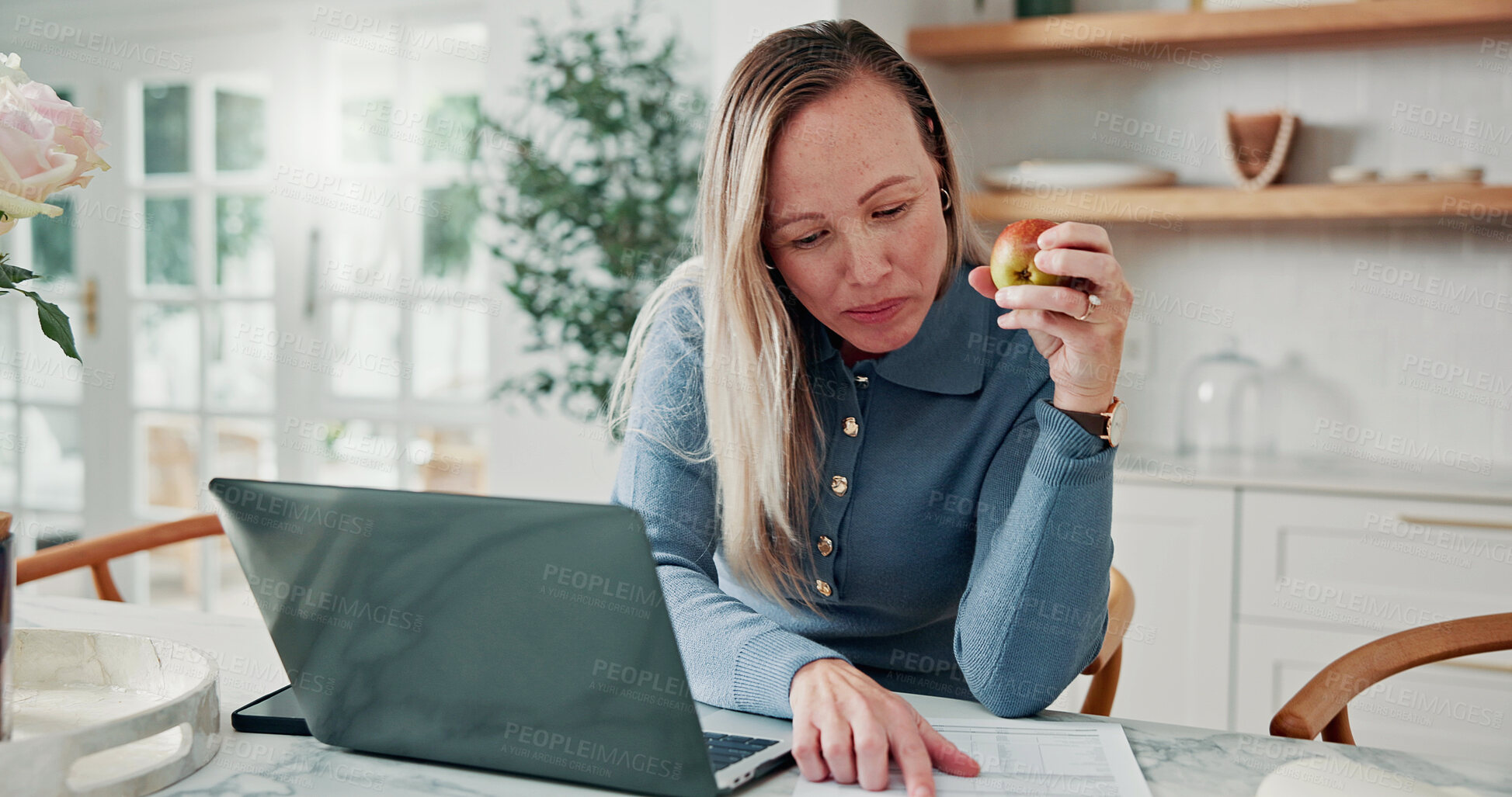 Buy stock photo Document, laptop or woman in house with apple, expense auditing or cost control in budget review. Reading, paperwork or home in kitchen with fruit, tax planning or savings track in money management.