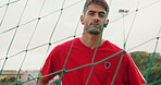 Net, fitness and portrait of soccer player on field for game, match or training for scholarship. Sports, serious man and athlete with confidence for football, exercise or practice skill outdoor.