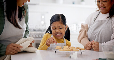 Buy stock photo Family, baking and cookies in home with child, learning and bonding with homemade treats. Mother, grandmother and biscuits in kitchen with daughter, culinary skills and anticipation for baked dessert