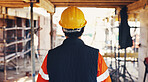 Man, back and walking for construction site, inspection and contractor compliance with helmet. Safety manager, maintenance and quality assurance for renovation, engineering or project management