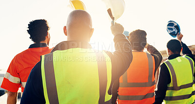 Buy stock photo Back, construction site and team celebration for foundation finish, inspection pass or support. Sunshine, flare and excited men with helmet for building progress, compliance success and cheer