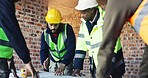 Engineer, blueprint and architect with team in discussion, meeting and planning at construction site. Men, group collaboration and project or floor plan for renovation, expansion or building process