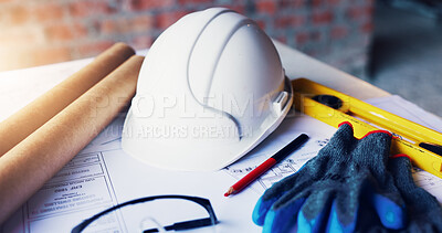 Buy stock photo Helmet, architecture and tools in empty office with engineering gloves, blueprint or design. Construction, equipment and safety ppe at building site with development paperwork, layout and drawing