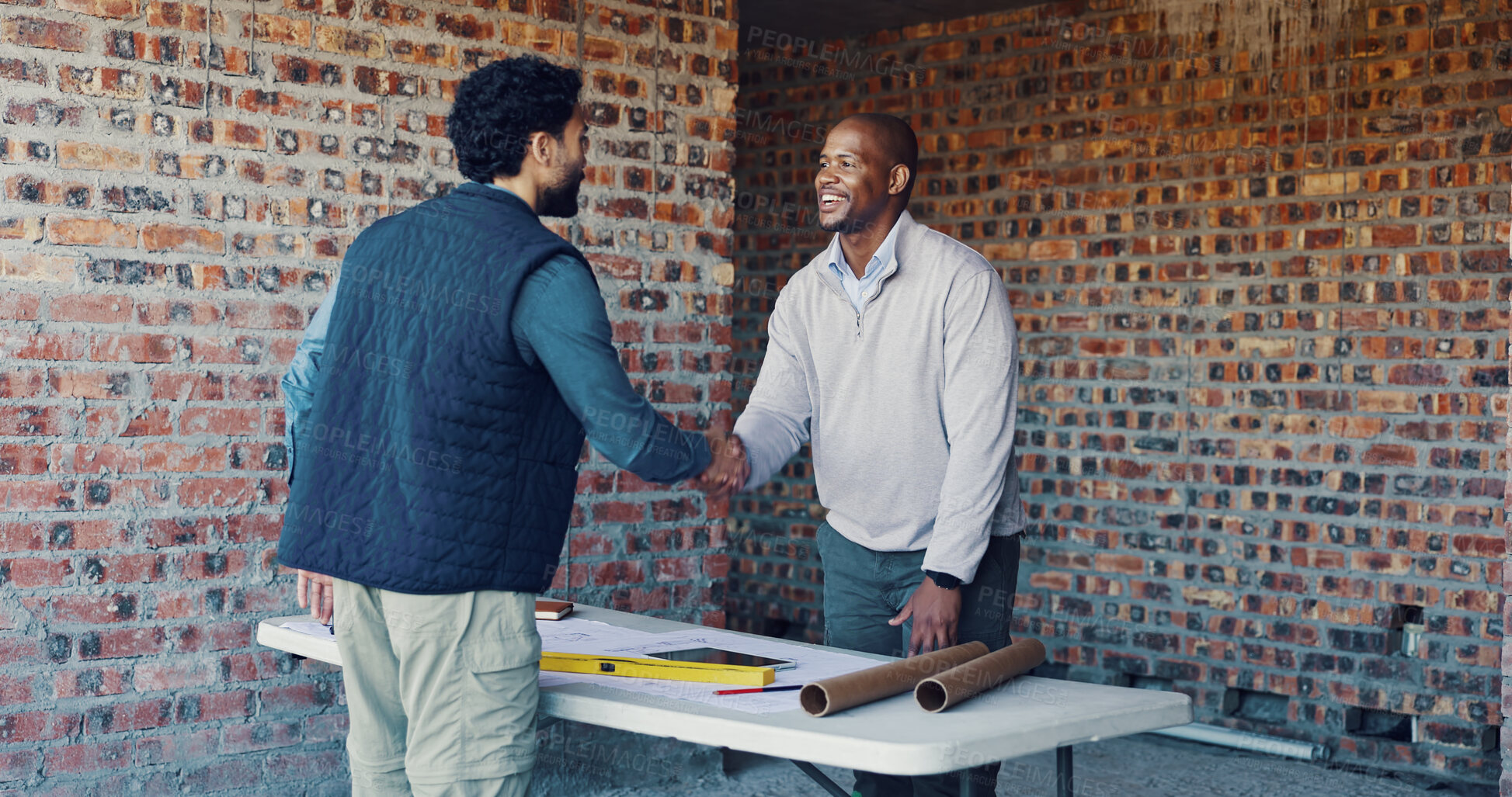 Buy stock photo Engineer, architect and handshake with partner in agreement, deal and planning at construction site. Happy men, team collaboration and shaking hands for onboarding, expansion or building success