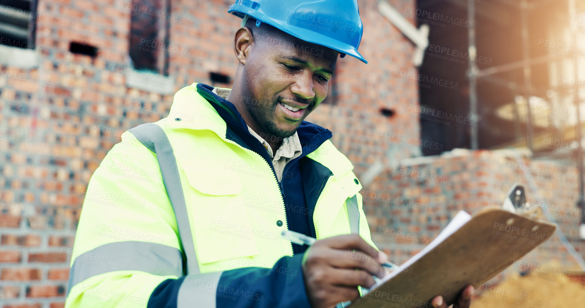 Buy stock photo Architect, writing and black man with clipboard on construction site for building inspection. Male person, contractor or civil engineer with smile or checklist for architecture safety or security