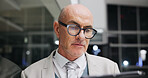 Serious, businessman and research on tablet at night, investment banking and project deadline on web. Mature person, working late and business analyst with info, online and financial review with tech