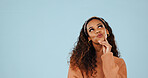 Thinking, space and woman in studio with planning, problem solving or brainstorming on decision. Choice, ideas and female person by blue background with solution, memory or reflection for question.