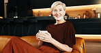 Smile, coffee and mature woman in home, portrait and rest with peace on weekend break. Morning beverage, calm and happy person in living room for wellness, self care and staycation at apartment