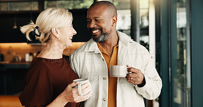 Buy stock photo Smile, couple and relax in home with coffee, love and partner affection for weekend break. Happy, interracial mature people and laugh at house with drinks, admiration and romance for bonding together