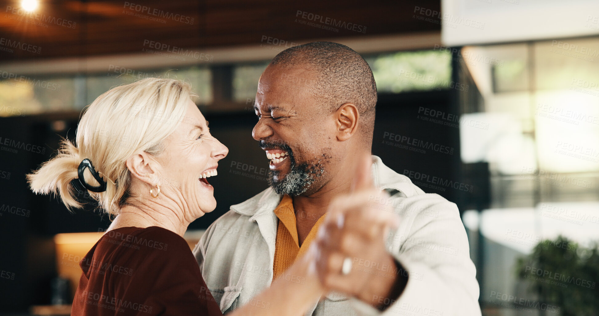 Buy stock photo Couple, laugh and holding hands at house for dancing, support and romance for anniversary. Happy, interracial mature people or rhythm in home with partner, listening to music and romantic celebration