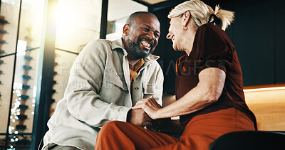 Buy stock photo Interracial couple, holding hands and smile with love, conversation or commitment for relationship. Happy, mature people and security with embrace, romance and laugh with bonding and partner in home
