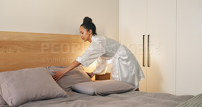 Buy stock photo Pillow, morning and woman making bed in hotel for daily routine, fresh fabric or maintenance. Change, cleaning and tidy with person in bedroom of accommodation for chores, housework or responsibility