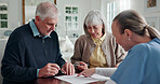 Caregiver, old couple and reading in home with document, form and signature for medical consent. Smile, nurse and senior people in lounge with contract, application and agreement for health insurance