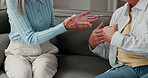 Couple, hands or fight on sofa in home discussion with conflict for argument or disagreement. Relationship, breakup or people in living room dispute for confession, marriage or confrontation in house