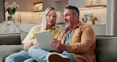 Buy stock photo Couple, relax and conversation in home with tablet, browsing social media or digital app for news. Married, mature man and woman on sofa with tech, reading article or discussion for bonding together.