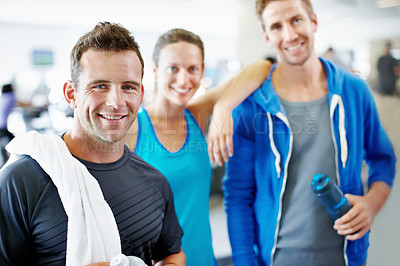 Buy stock photo Portrait of a young man standing with his friends at the gym