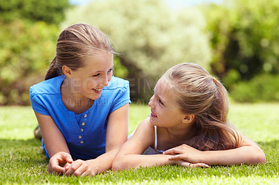 Buy stock photo Relax, children and sister love on grass for summer break, relationship development and talking. Happy family, girls and conversation in nature for holiday, sibling connection and bonding on weekend