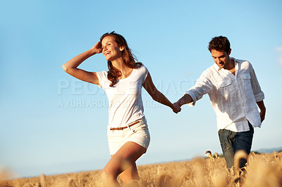 Buy stock photo Holding hands, love and walking with couple in field for honeymoon getaway, support and trust. Care, connection and date with man and woman in countryside for loyalty, holiday and travel together