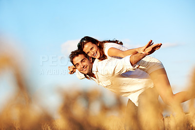 Buy stock photo Couple, portrait and piggyback in nature, laugh and bonding with partner on break, love and together. Outdoor, freedom and happy people on summer vacation, connection and low angle on adventure
