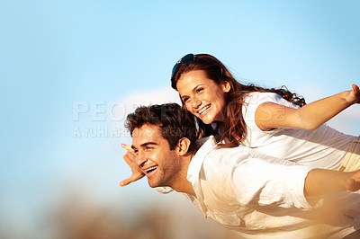 Buy stock photo Couple, laughing and piggyback in nature, playful and fly with partner on break, bonding or together. Outdoor, freedom and happy people on summer vacation, love and low angle on weekend adventure