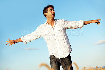 Buy stock photo Smile, blue sky and man in field with open arms, freedom and happiness for holiday or vacation. Countryside, nature and person with wellness, fresh air and thinking for break, weekend and travel