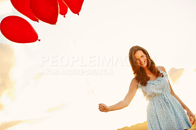 Buy stock photo Balloons, woman and portrait with sunset for freedom, vacation or happy for travel fun. Smile, girl or excited outdoor for weekend trip with holiday, confidence and celebration for adventure at space