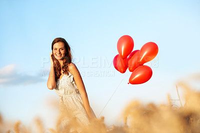 Buy stock photo Celebration, woman and happy with balloons in field for birthday getaway, portrait and growth. Travel, person and smile with countryside party for personal milestone, weekend trip and special event