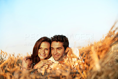 Buy stock photo Countryside, relax and couple in field for love, bonding and connection on summer weekend. Dating, happy and man with woman with blue sky, nature and space for relationship, trust and holiday outdoor
