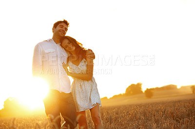 Buy stock photo Hug, sunset and love with couple in field for honeymoon getaway, support and trust. Care, connection and date with man and woman in countryside for loyalty, holiday space and travel together