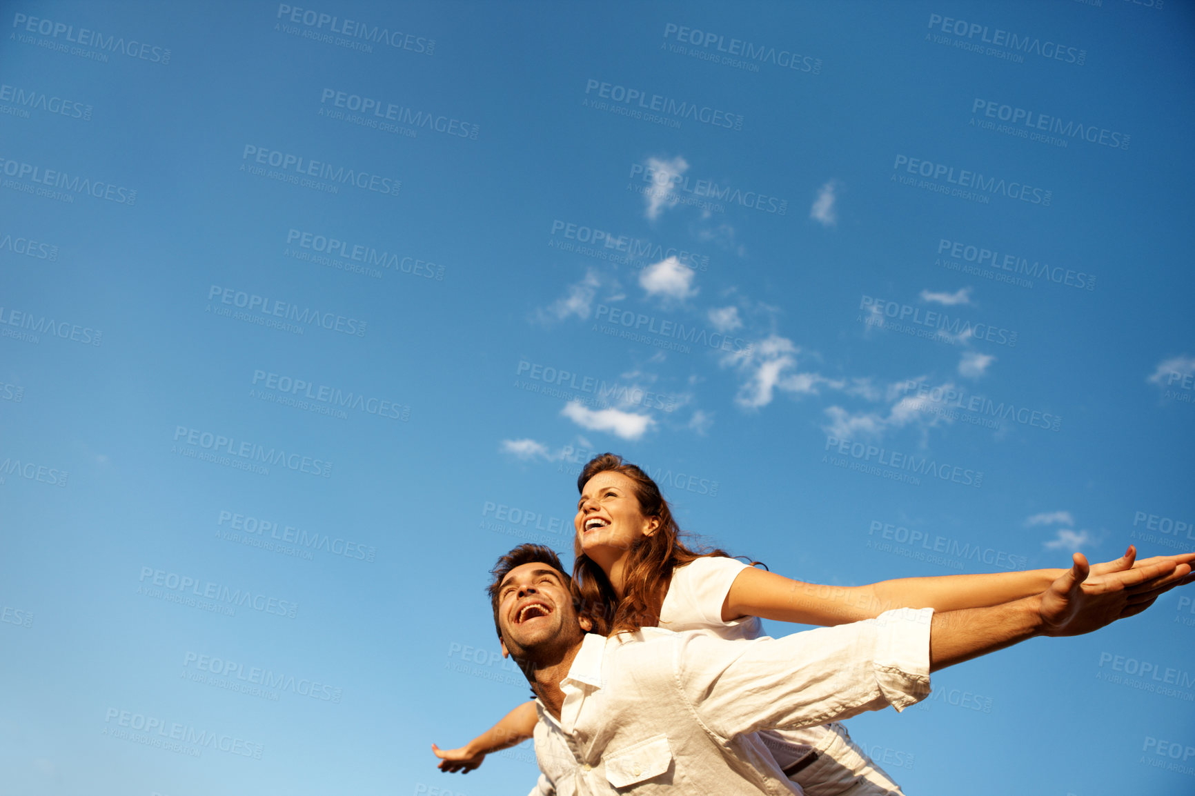 Buy stock photo Couple, flying and piggyback on vacation, sky and playful with partner on weekend, love and together. Outdoor, freedom and happy people on summer holiday, mockup space and low angle on adventure