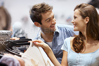 Buy stock photo Talking, shopping and couple in store with decision on clothes with promotion, sale or deal. Happy, bonding and man with woman for choice on outfit together for discount in boutique at retail mall.